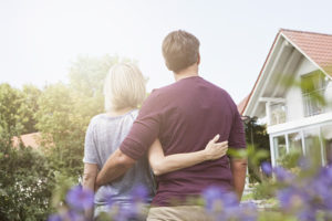 Couple in garden looking at house