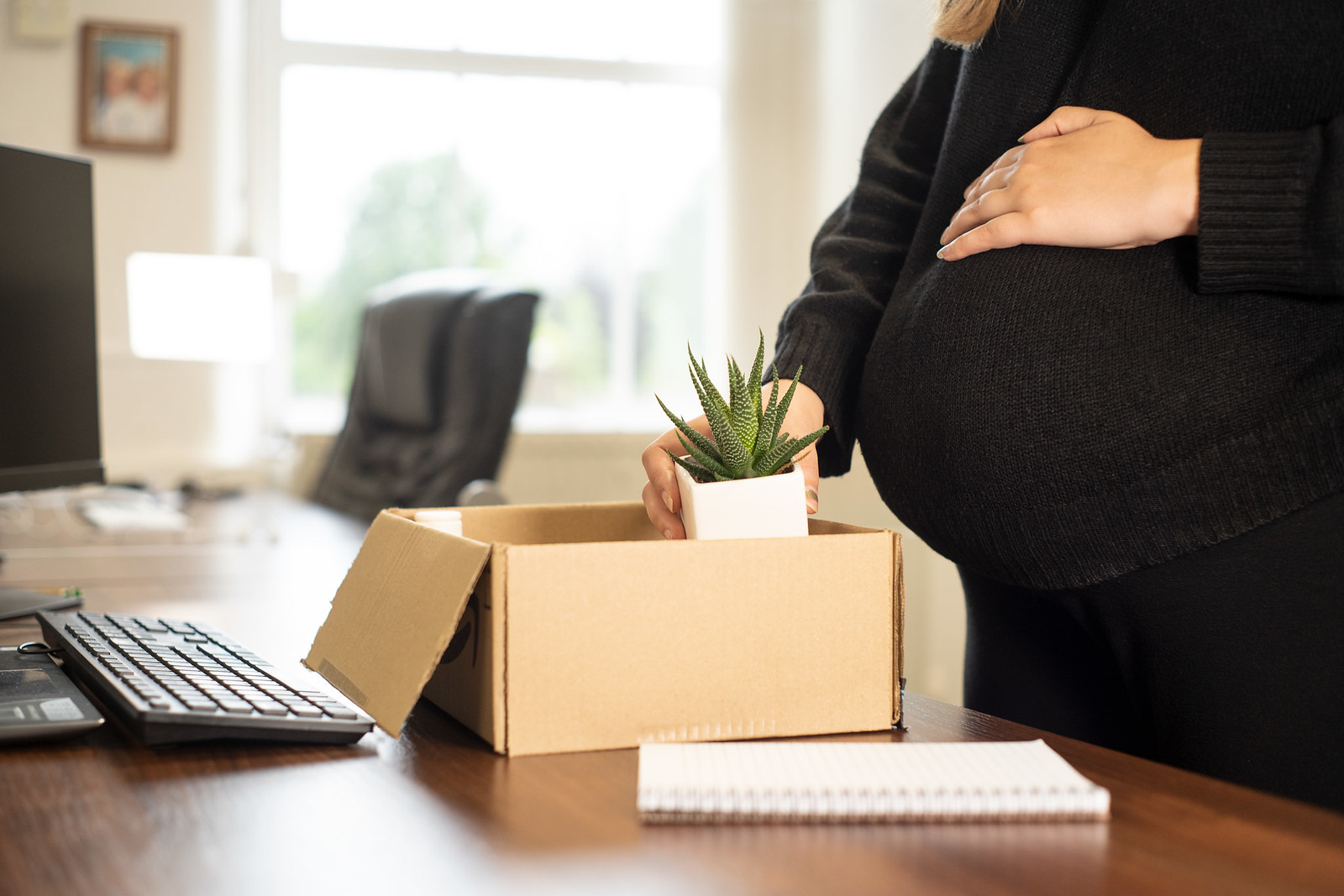 Pregnant woman moving desks