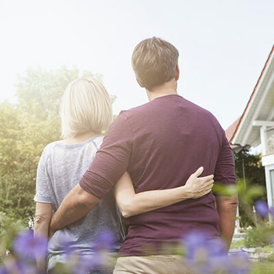 Couple in garden looking at house