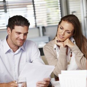 A young couple going over some documents with their financial advisor